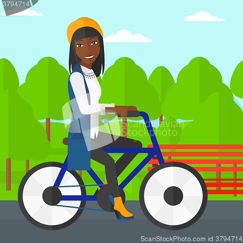 Image of Woman riding bicycle.