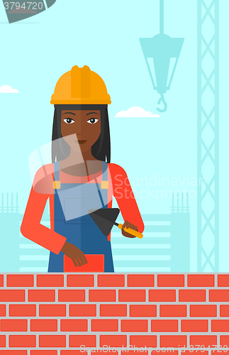 Image of Bricklayer with spatula and brick.