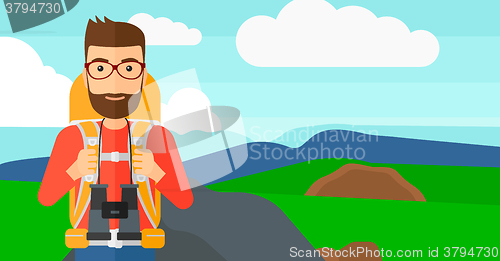 Image of Cheerful backpacker with binoculars.