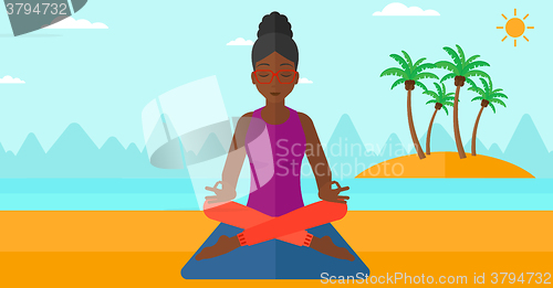 Image of Woman meditating in lotus pose.