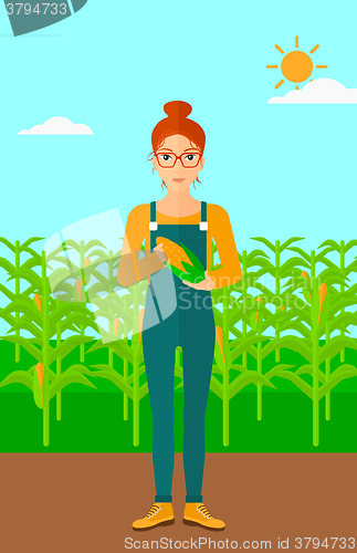 Image of Farmer holding corn.