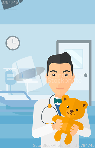 Image of Pediatrician holding teddy bear.