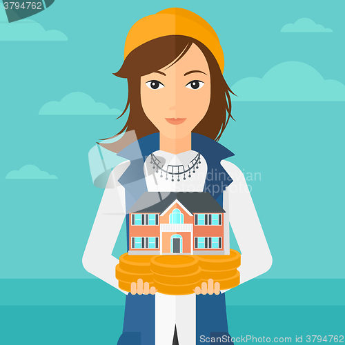 Image of Woman holding house model.