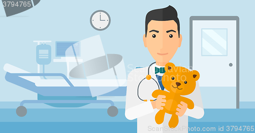 Image of Pediatrician holding teddy bear.