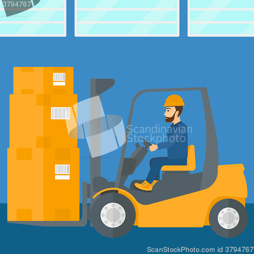 Image of Warehouse worker moving load by forklift truck.