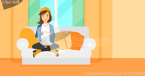 Image of Pregnant woman sitting on sofa.