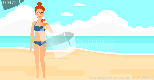 Image of Tourist with cocktail on the beach.