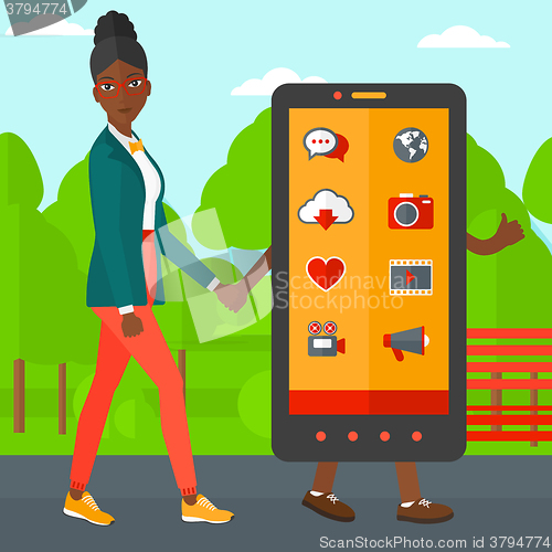 Image of Woman walking with smartphone.