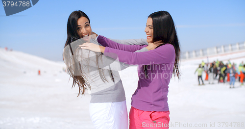 Image of Joking women strangling each other