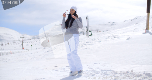 Image of Attractive young woman standing in winter snow
