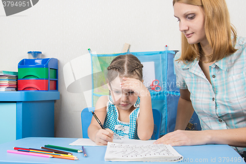 Image of Five-year girl thought doing a spelling tutor