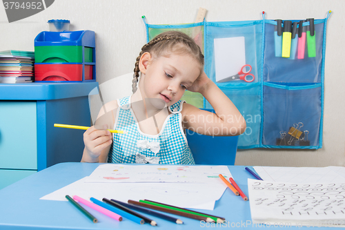 Image of Happy five year old girl wondered drawing pencil