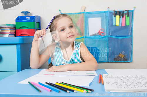 Image of Five-year girl scratched his head and wondered pencil drawing picture at table