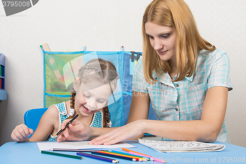 Image of Girl happily looks at painted with the help of drawing the line