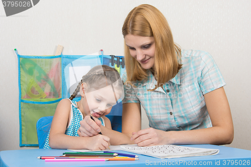 Image of Mentor and five children together correctly written letter of the alphabet