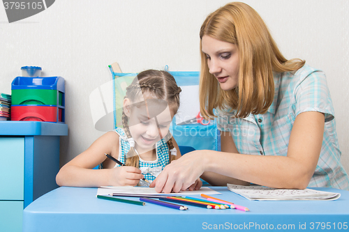 Image of Girl and mother fun in a notebook draw