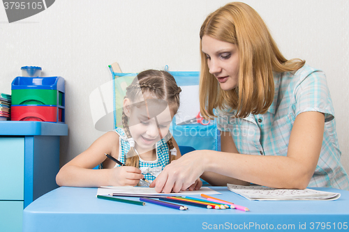 Image of Girl and mother fun in a notebook draw