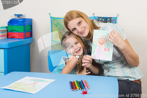 Image of My mother and five year old daughter hugging and show painted a 