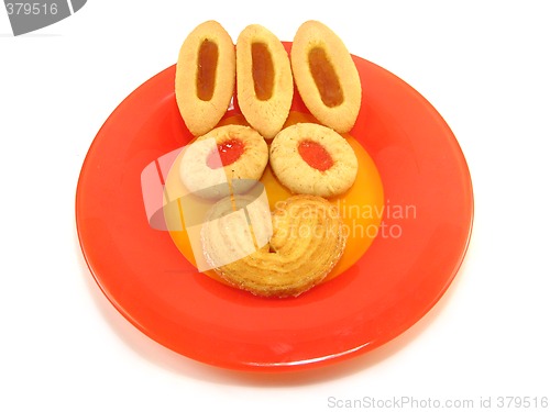 Image of biscuit and tarts on a red plate