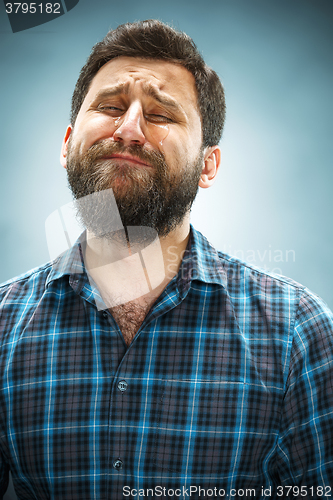 Image of The crying man with tears on face closeup