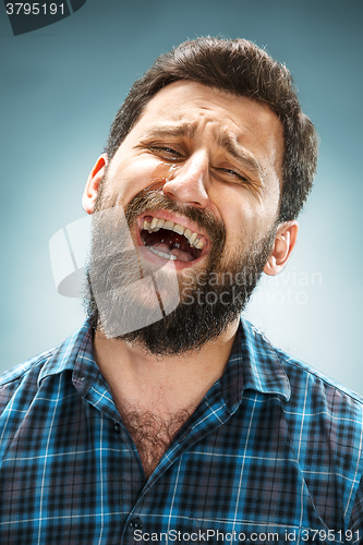 Image of The crying man with tears on face closeup