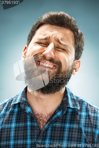 Image of The crying man with tears on face closeup