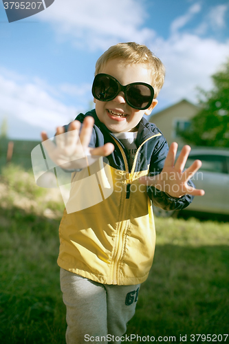 Image of Happy boy in big sunglasses outdoor