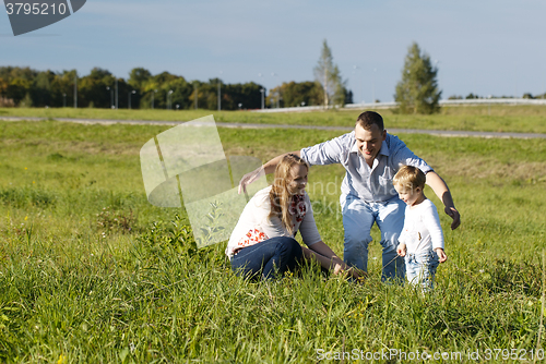 Image of Protective father playing with his wife and son