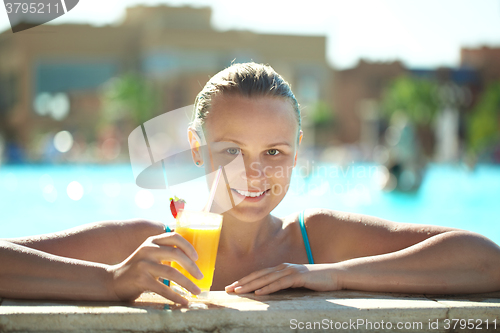 Image of Beautiful young woman drinking a cocktail