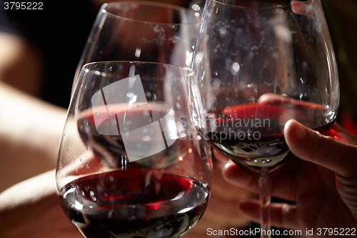 Image of Three red wine glasses.