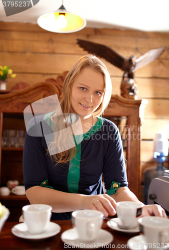 Image of Woman makes coffee.