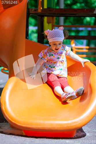 Image of Small girl having fun on a slide