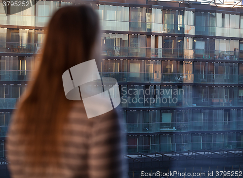 Image of Woman looking at an apartment block