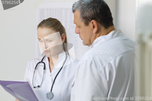 Image of The nurse reported to doctor about medical tests.