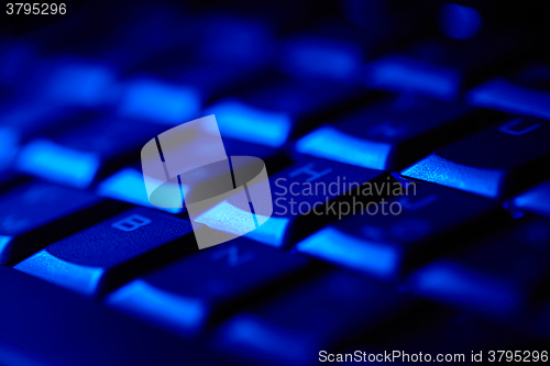 Image of Computer keyboard in blue light.