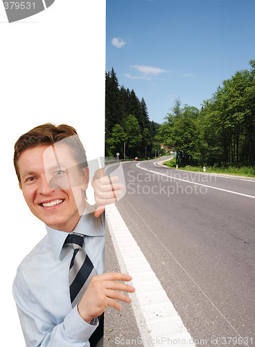 Image of Smiling business man holding a image against white