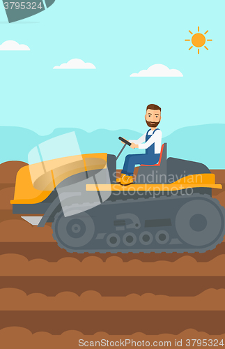 Image of Farmer driving catepillar tractor.