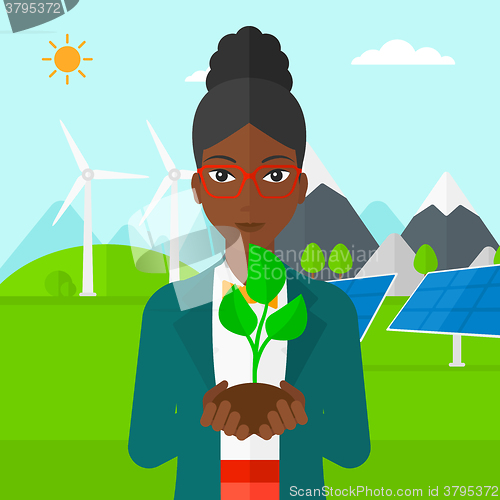 Image of Woman holding plant.