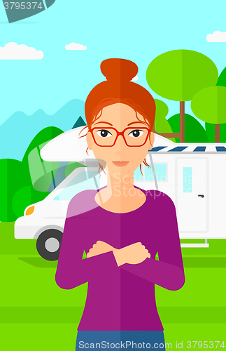 Image of Woman standing in front of motor home.