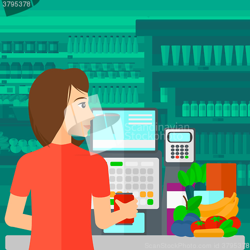 Image of Cashier at supermarket checkout.