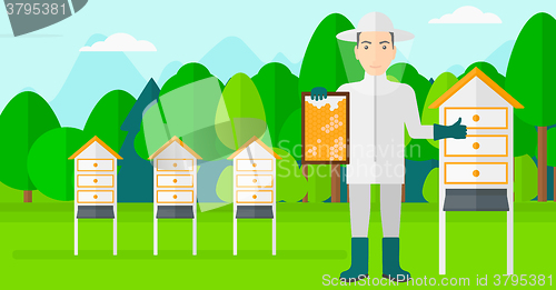 Image of Bee-keeper at apiary.