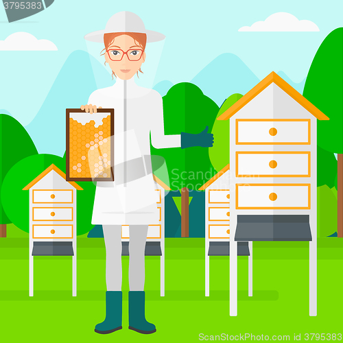 Image of Bee-keeper at apiary.