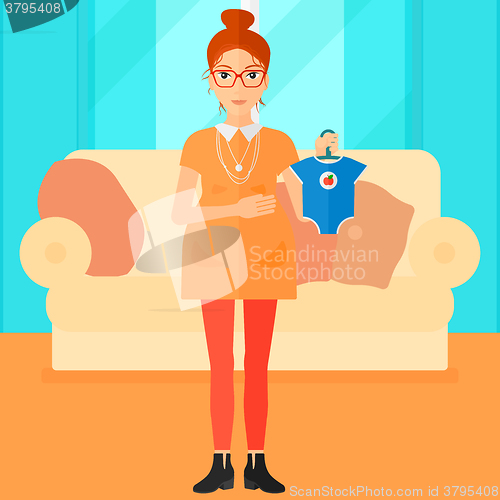 Image of Pregnant woman with clothes for baby.