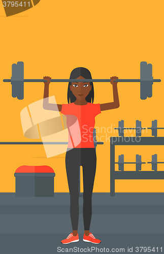 Image of Woman lifting barbell.