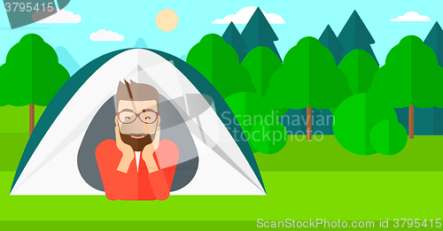 Image of Man lying in tent.