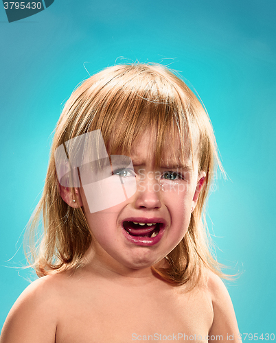 Image of Portrait of a little girl. She is crying
