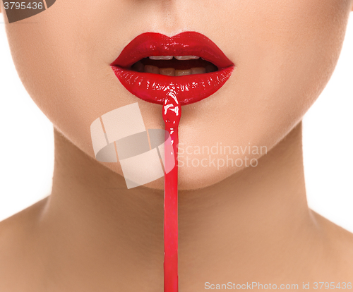 Image of Beautiful female lips with make-up and brush