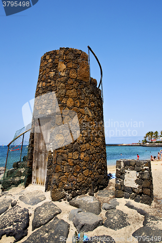 Image of tower  yellow  beach    black rocks in the   lanzarote 