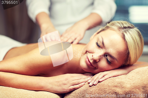 Image of close up of woman lying and having massage in spa