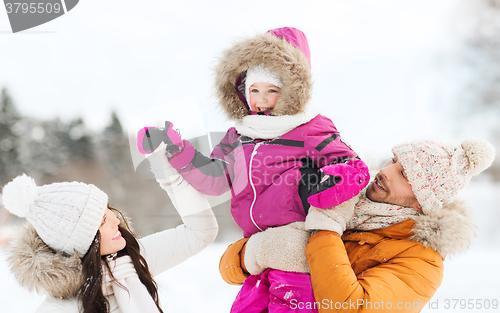 Image of happy family with child in winter clothes outdoors